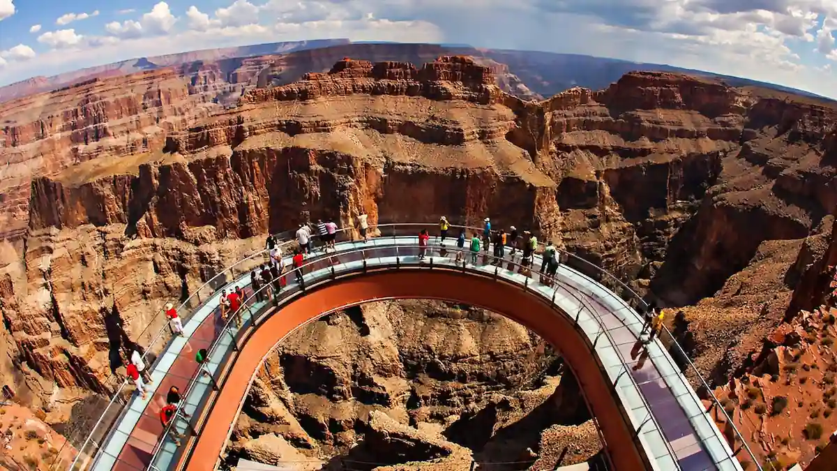 a group of people on a bridge over a canyon